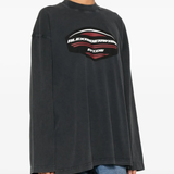 Black sweater worn by a person, showing the sweater fit