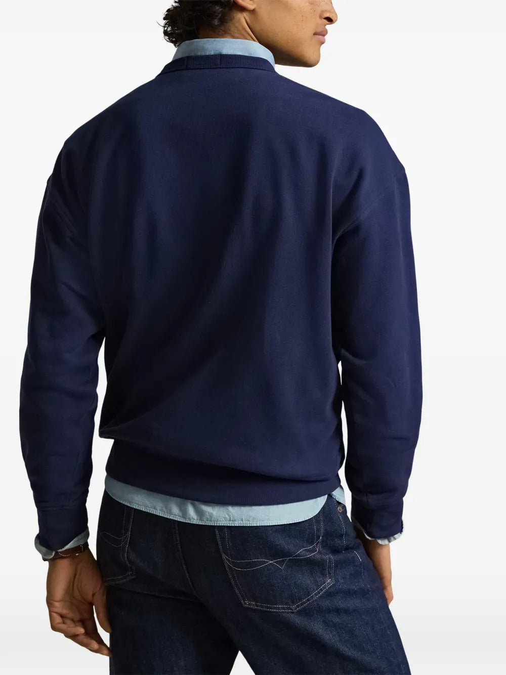 Navy shirts worn by a person, showing the shirts fit