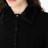 Close up of black knitwer, showing texture of the wool fabric