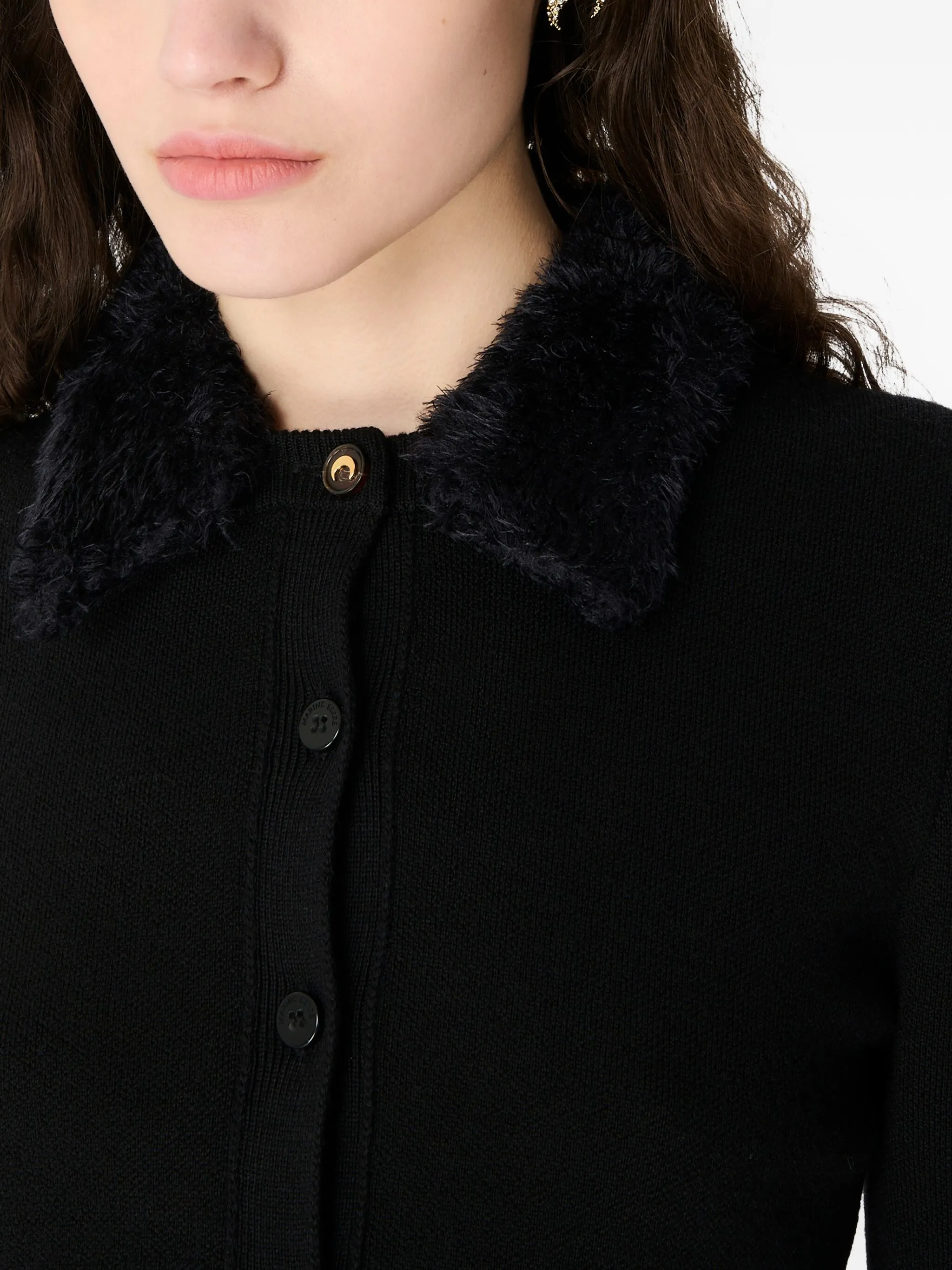 Close up of black knitwer, showing texture of the wool fabric