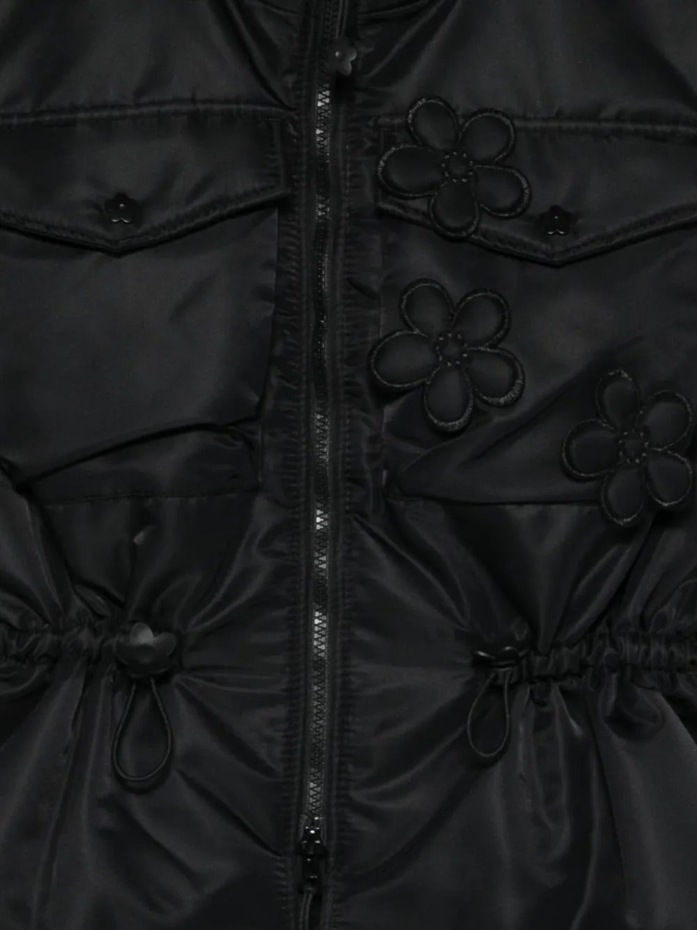 Close up of the black vest, showing texture of the polyamide fabric