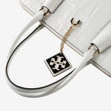 Close up of white bag, showing texture of the leather fabric