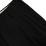 Close up of black pants, showing the detail on the waist