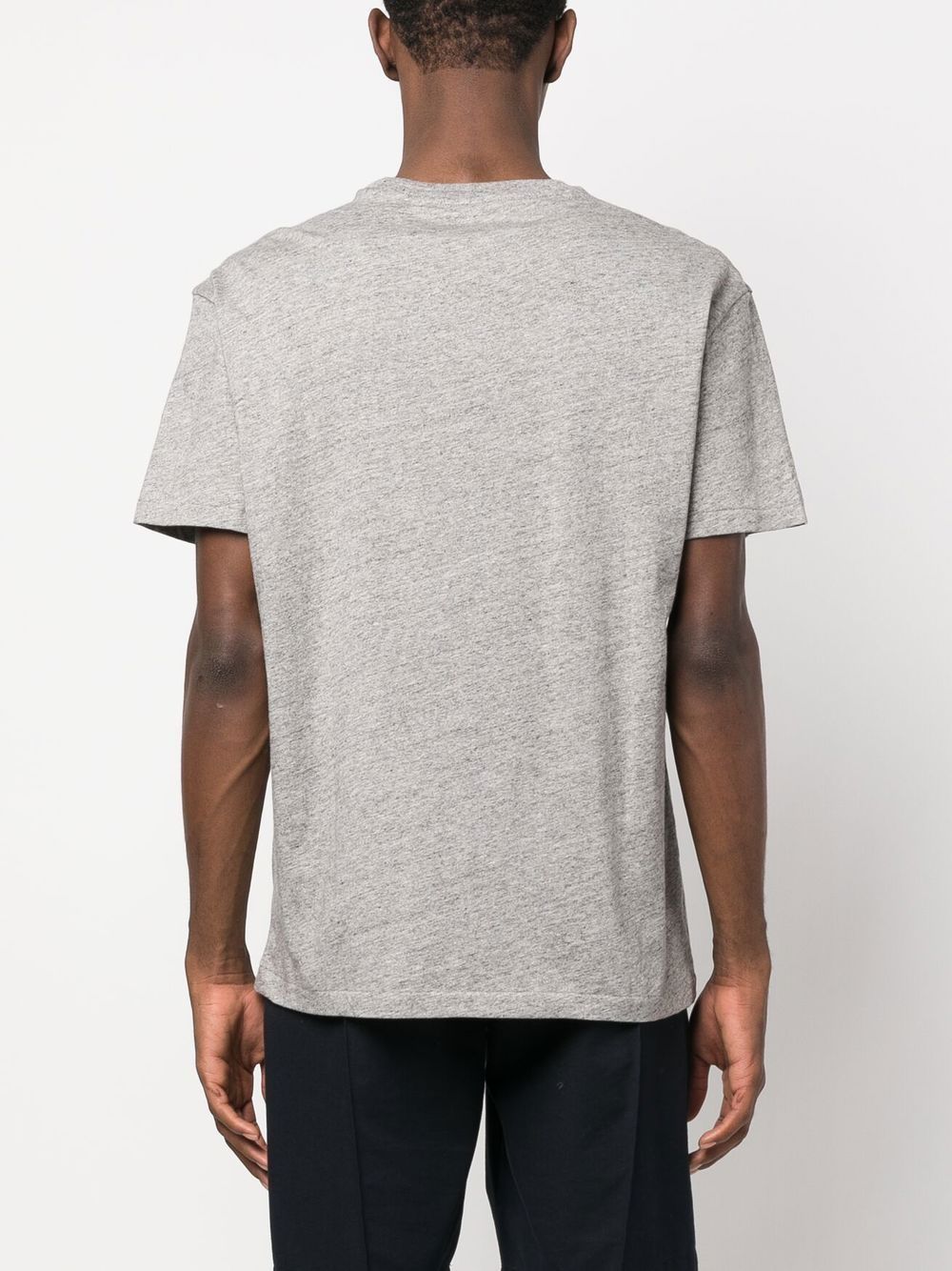 Grey shirt worn by a person, showing the shirt fit