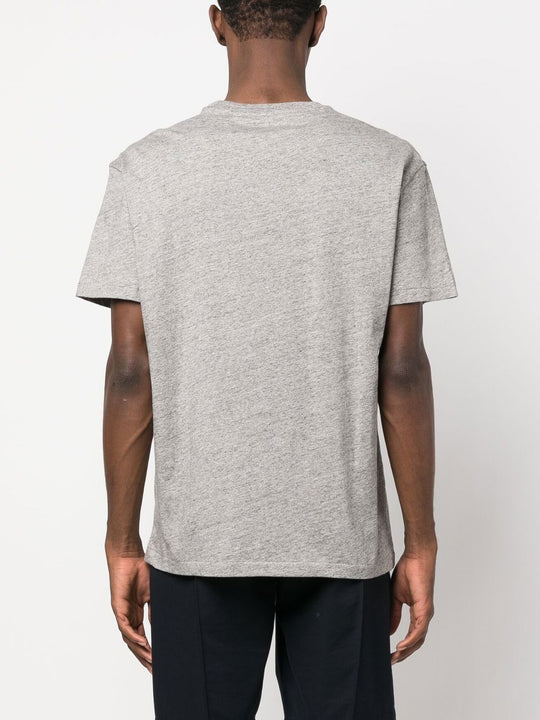 Grey shirt worn by a person, showing the shirt fit