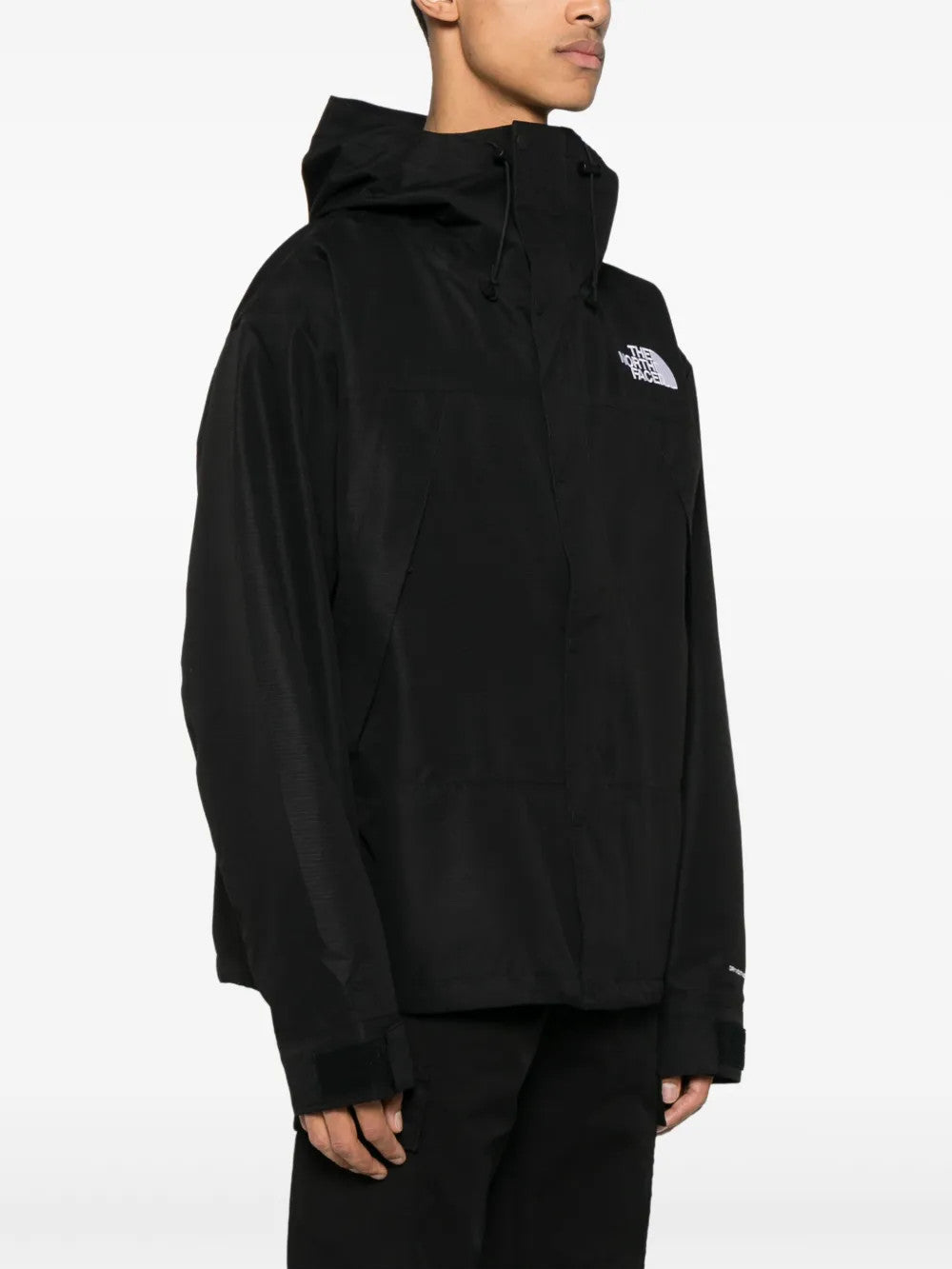 Black jacket worn by a person, showing the jacket fit