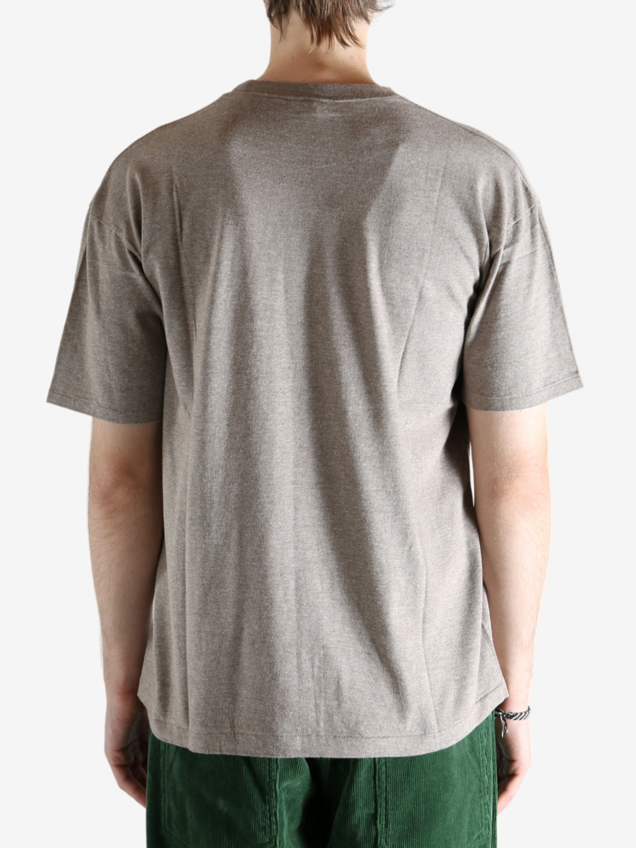 Brown t-shirt worn by a person, showing the shirt's fit