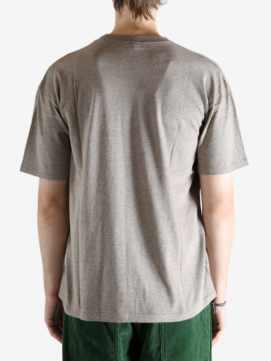 Brown t-shirt worn by a person, showing the shirt's fit