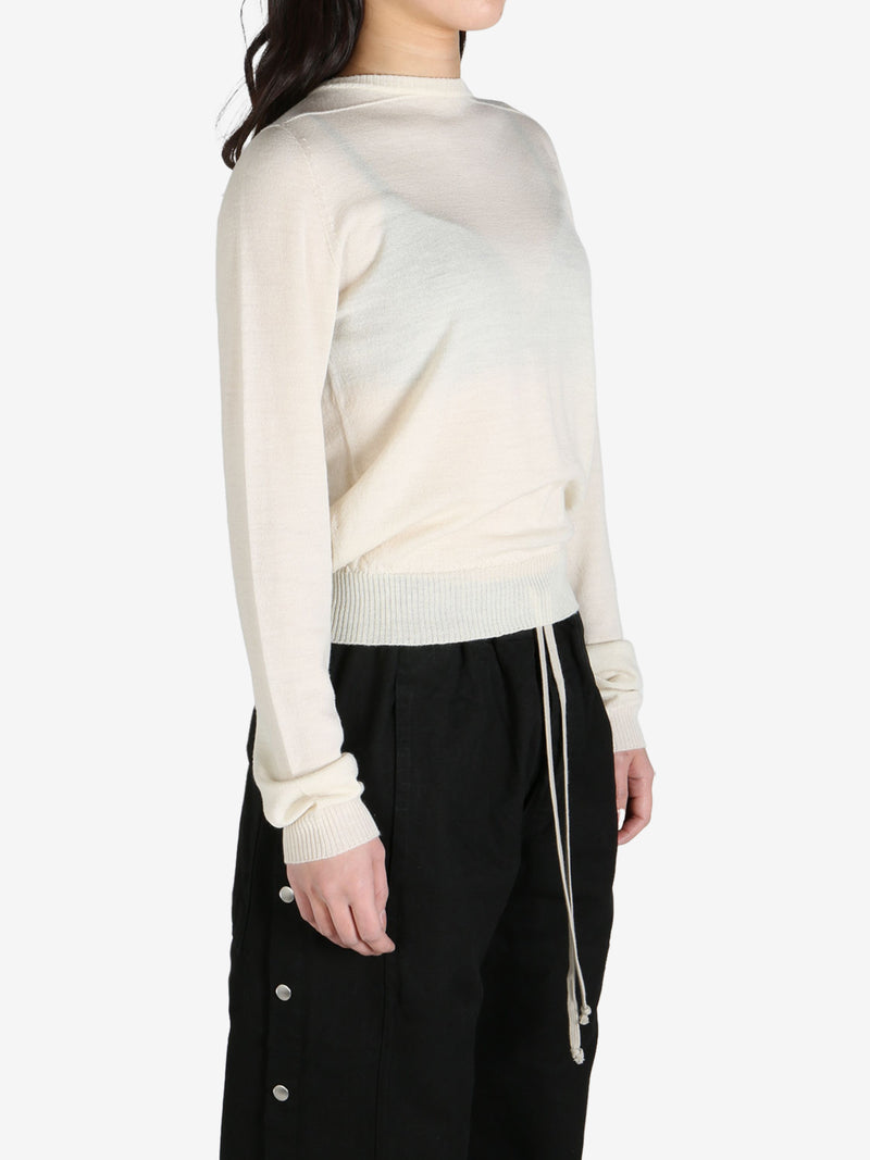 White sweater worn by a person, side view