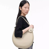 White bag worn by a person, showing the bag's fit