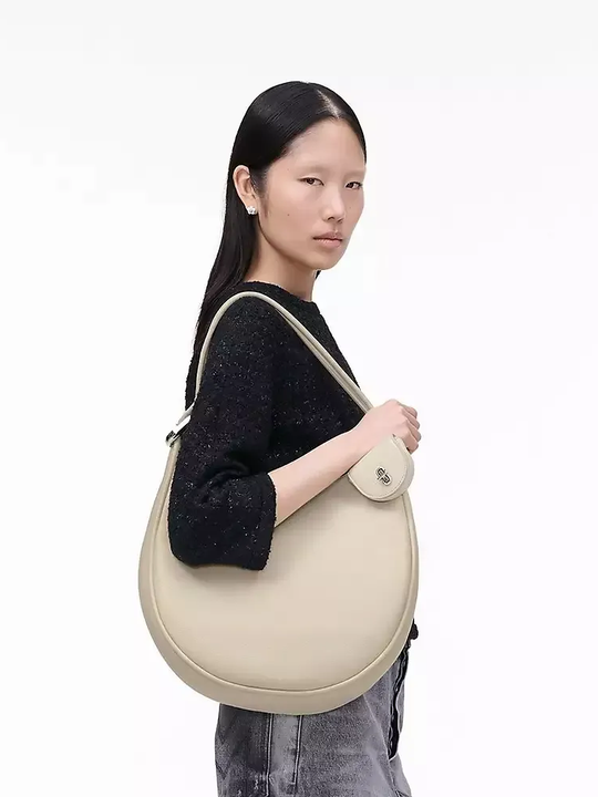 White bag worn by a person, showing the bag's fit
