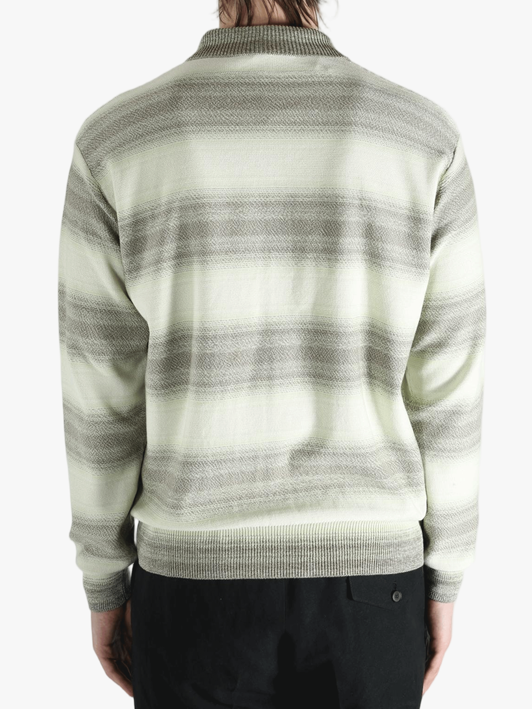 Grey knitwear worn by a person, showing the knitwear's fit