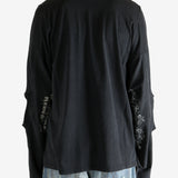 Black shirt worn by a person, showing the shirt fit