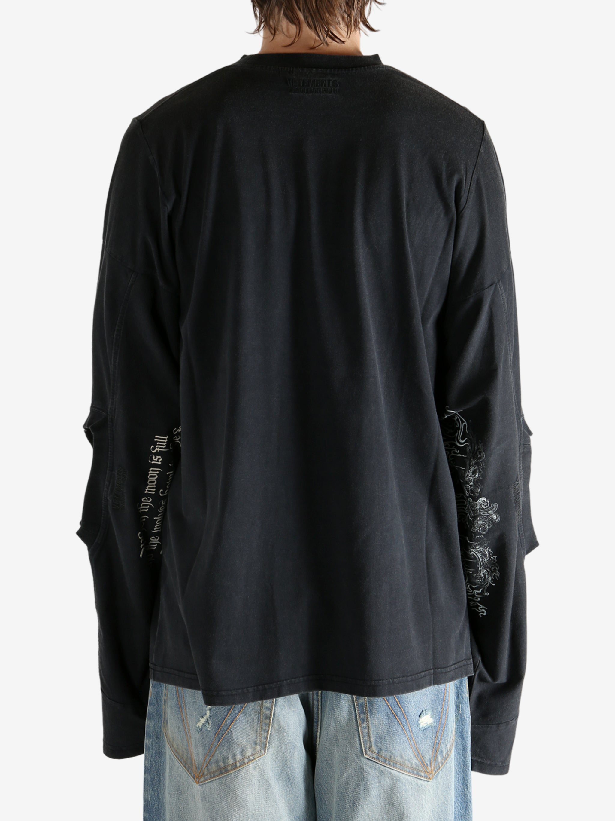 Black shirt worn by a person, showing the shirt fit