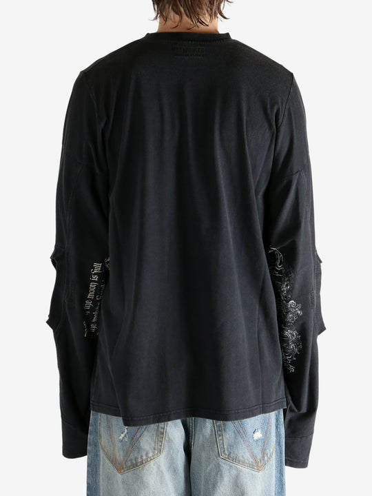 Black shirt worn by a person, showing the shirt fit