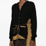 Black knitwear worn by a person, showing the knitwear fit