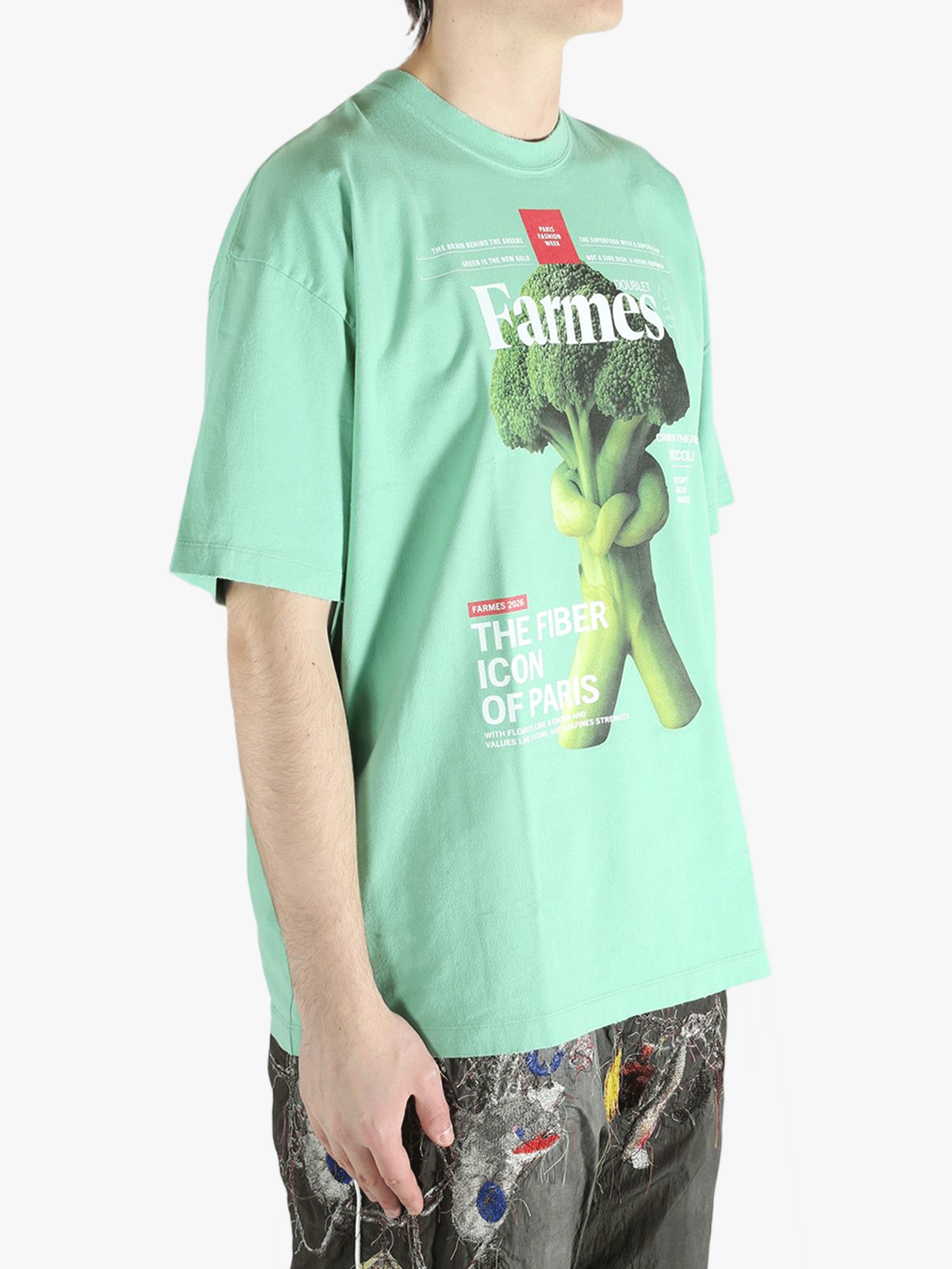 Green t-shirt worn by a person, showing the t-shirt's fit