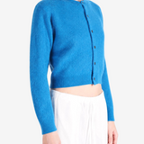 Blue knitwear worn by a person, showing the knitwear fit