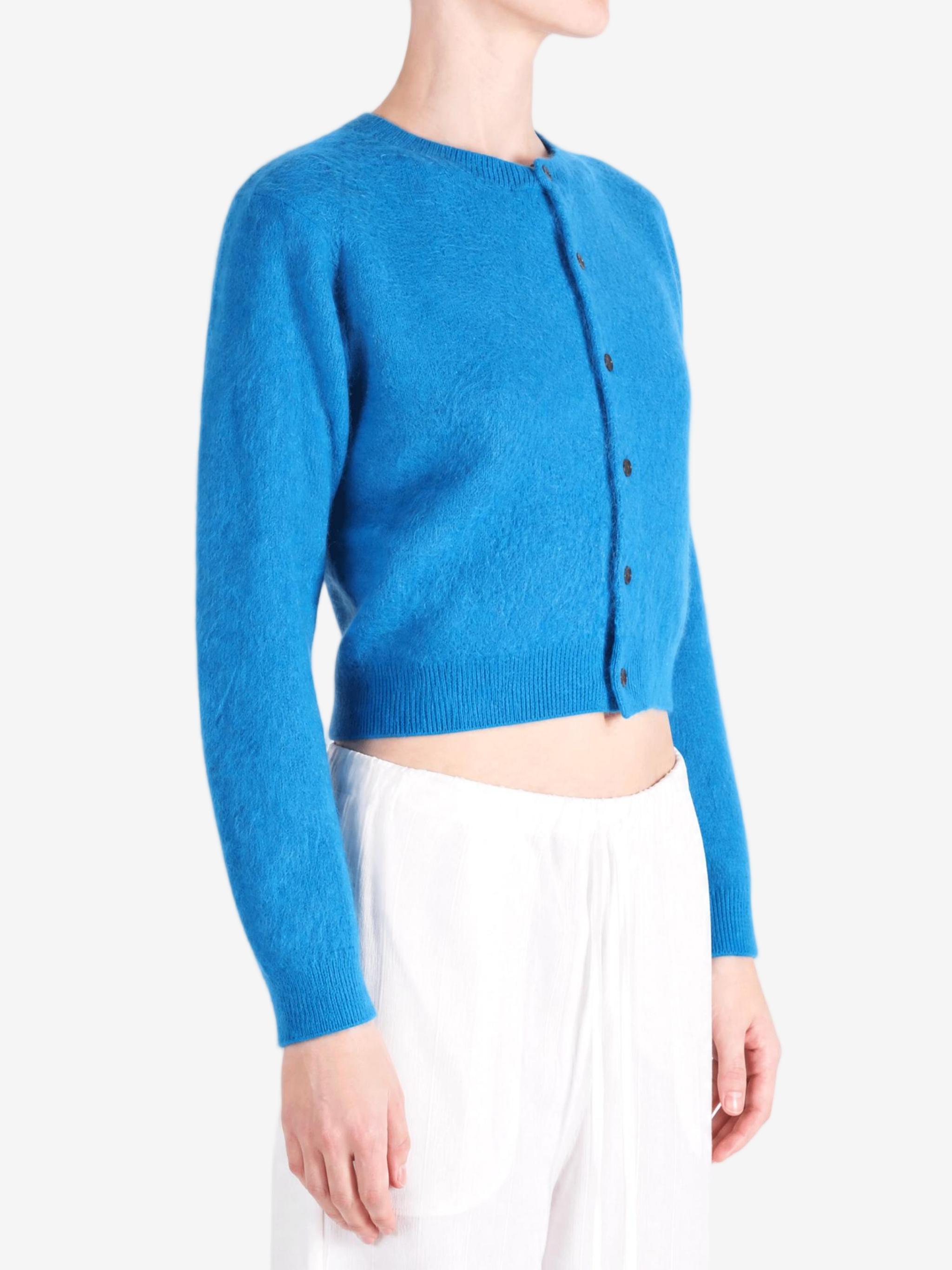 Blue knitwear worn by a person, showing the knitwear fit