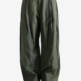 Green pants worn by a person, showing the pants' fit