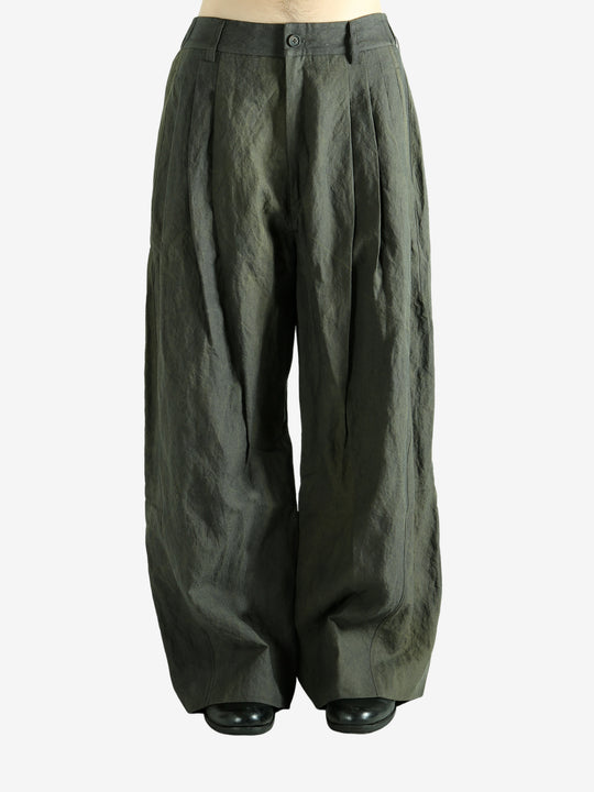 Green pants worn by a person, showing the pants' fit
