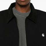 Black jacket worn by a person, showing the jacket fit