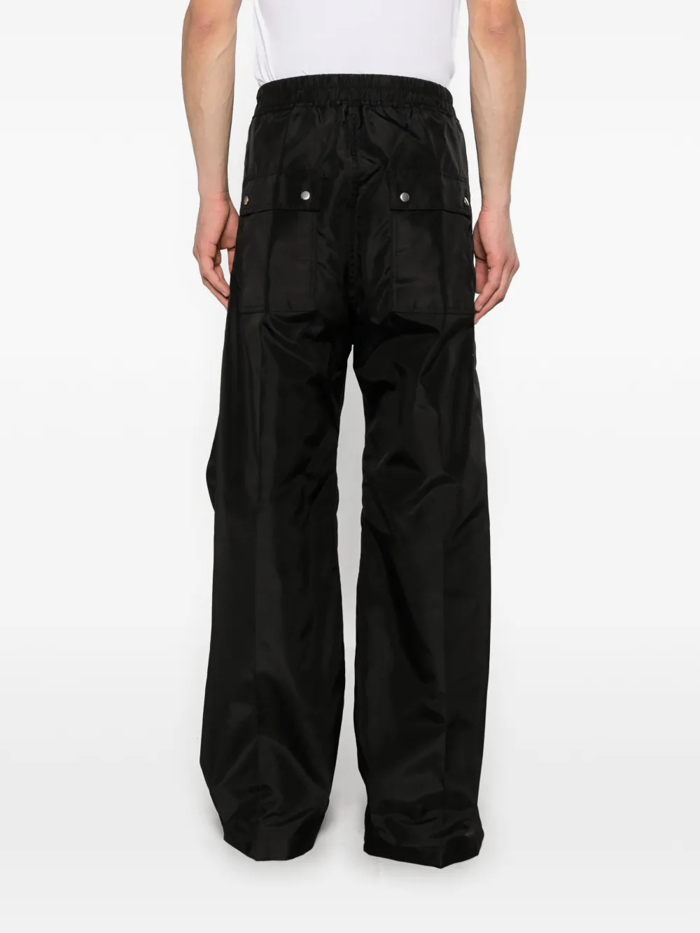 Black pants worn by a person, showing the pants fit