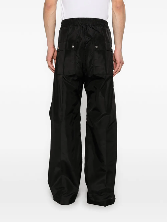 Black pants worn by a person, showing the pants fit