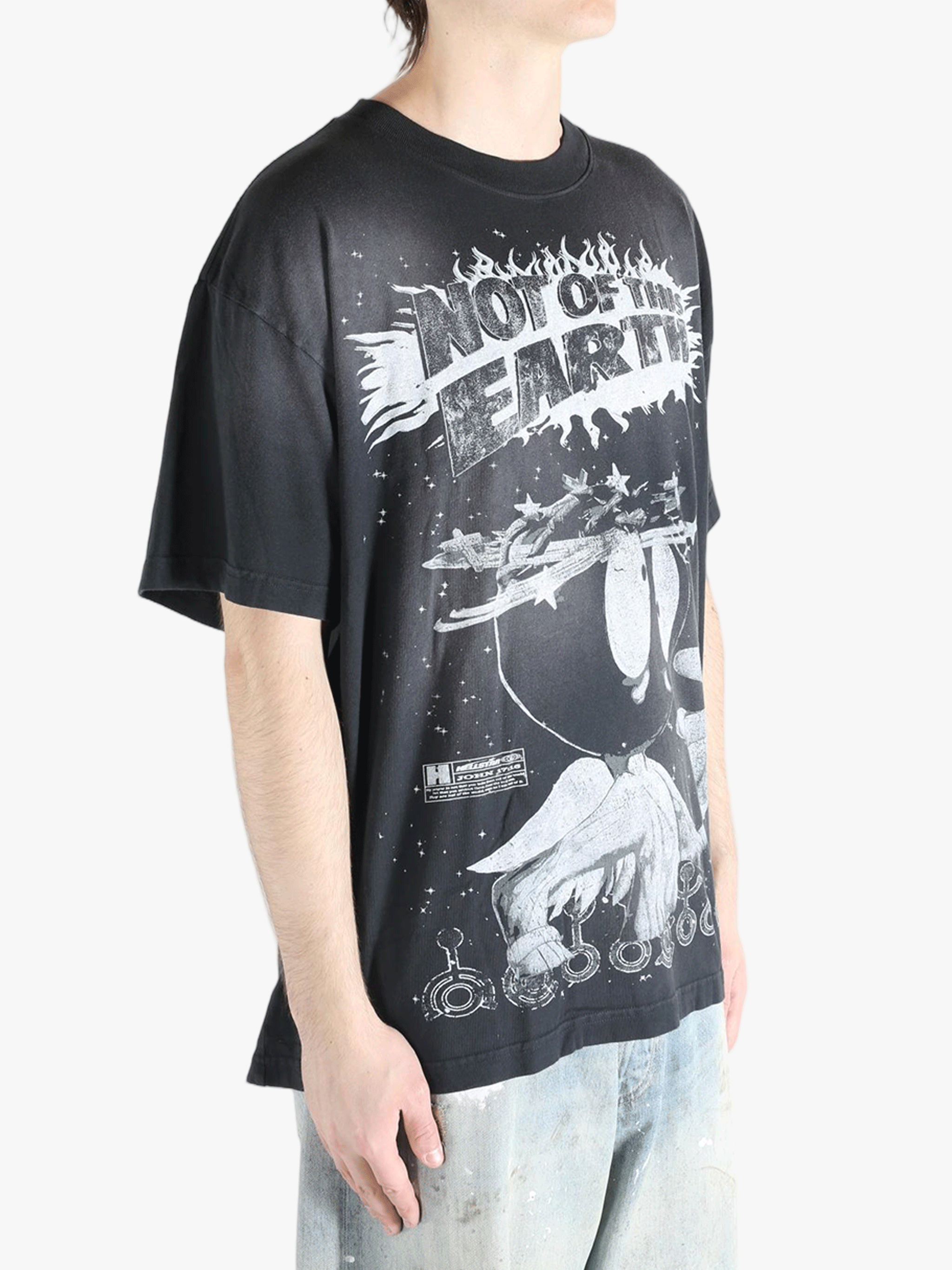 Black t-shirts worn by a person, showing the t-shirts fit