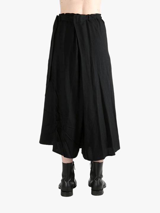 Black skirts worn by a person, showing the skirts fit