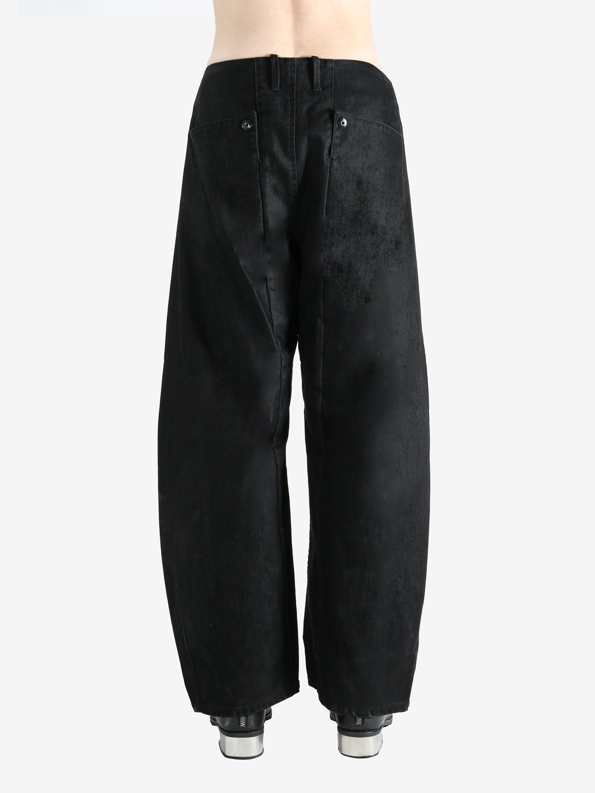 Black pants worn by a person, showing the pants fit