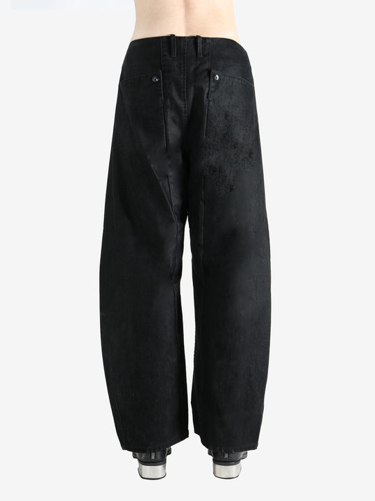 Black pants worn by a person, showing the pants fit