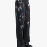Black pants worn by a person, showing the shirt's fit