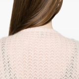 Close up of pink cardigan, showing the material detail of wool