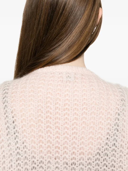 Close up of pink cardigan, showing the material detail of wool