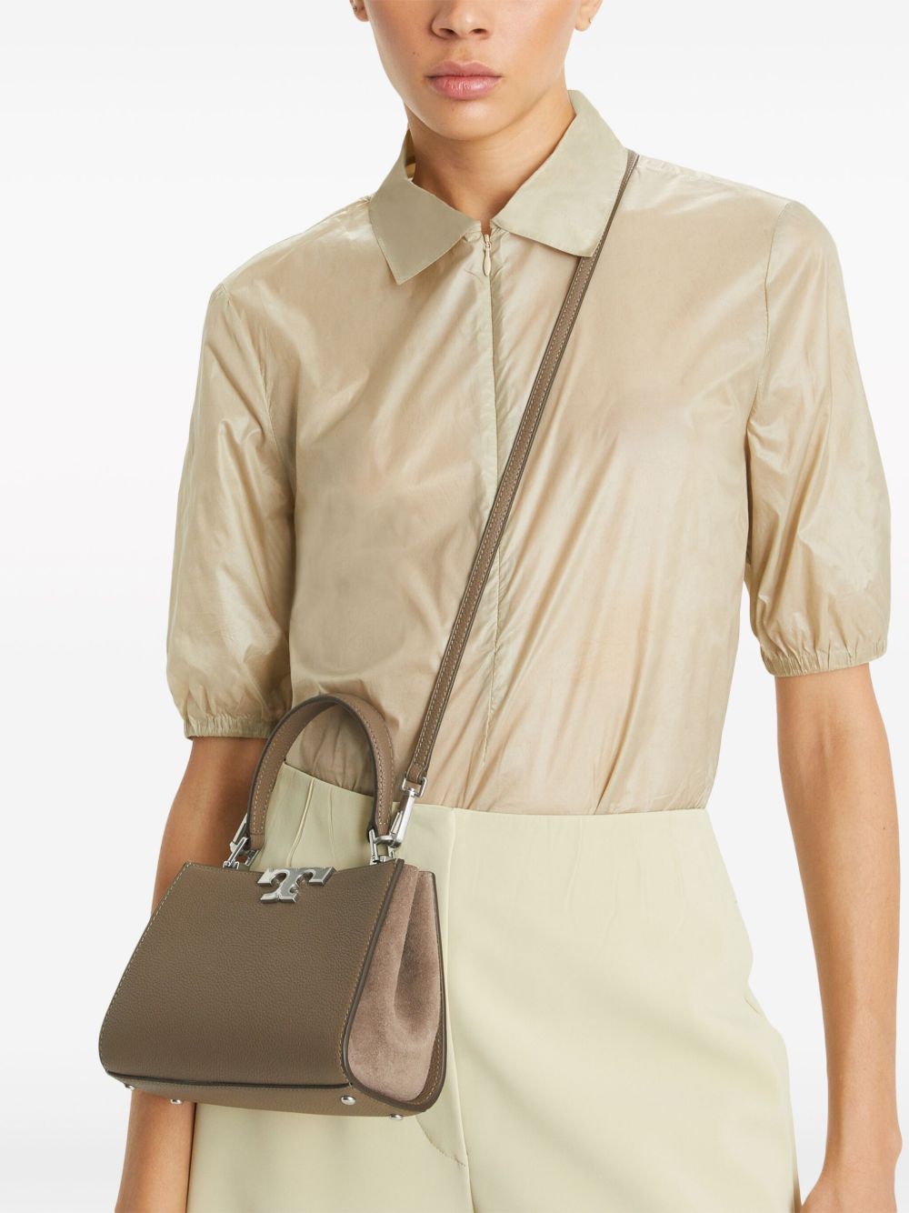 Brown bag carried by a person, showing the bag’s fit