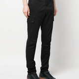 Black pants worn by a person, showing the black pants' fit