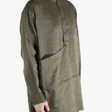 Grey top worn by a person, showing the top's fit