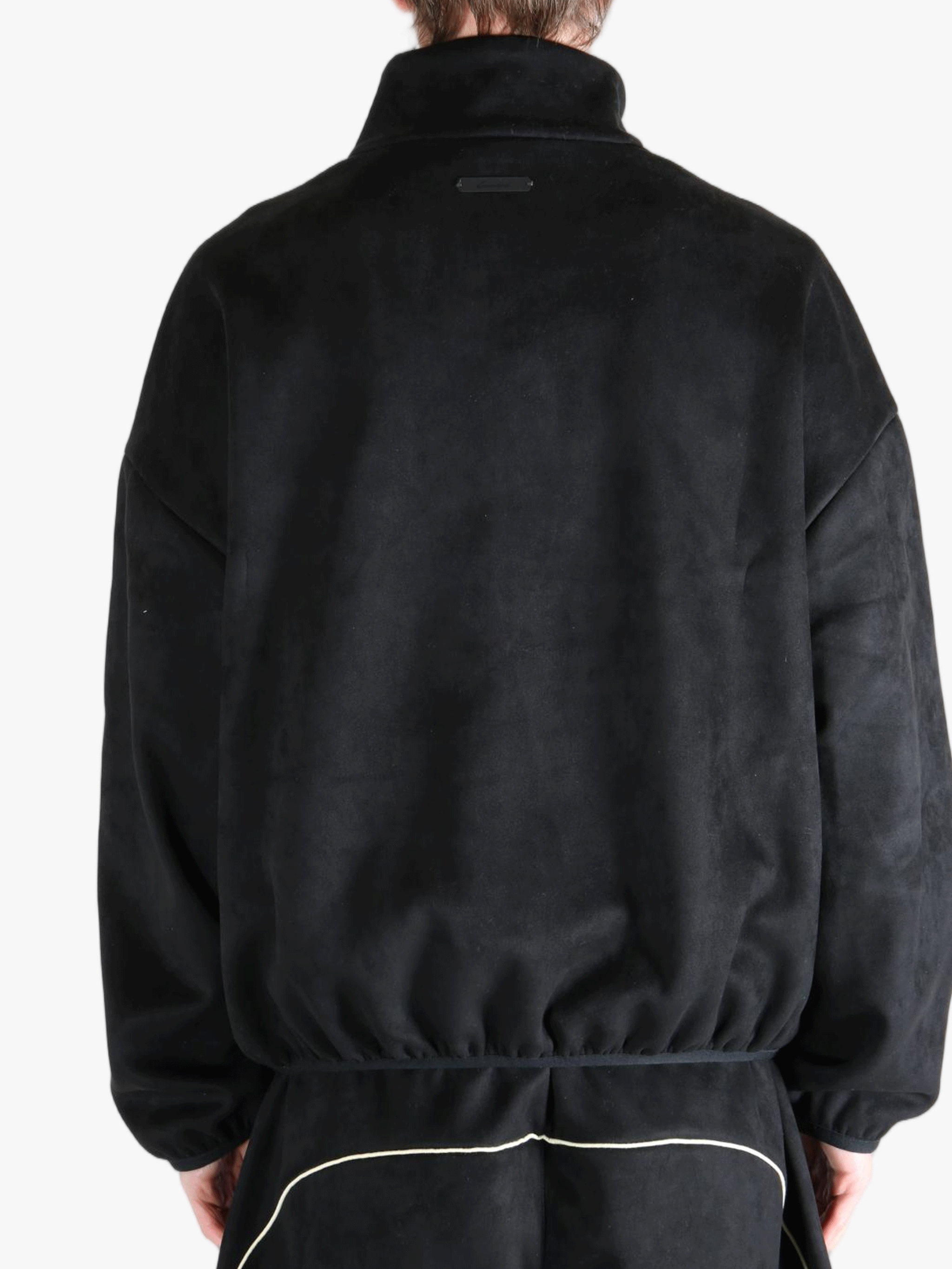 Black jacket worn by a person, showing the jacket's fit
