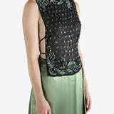 Green top worn by a person, showing the top fit