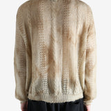 Tan knitwear worn by a person, showing the knitwear's fit
