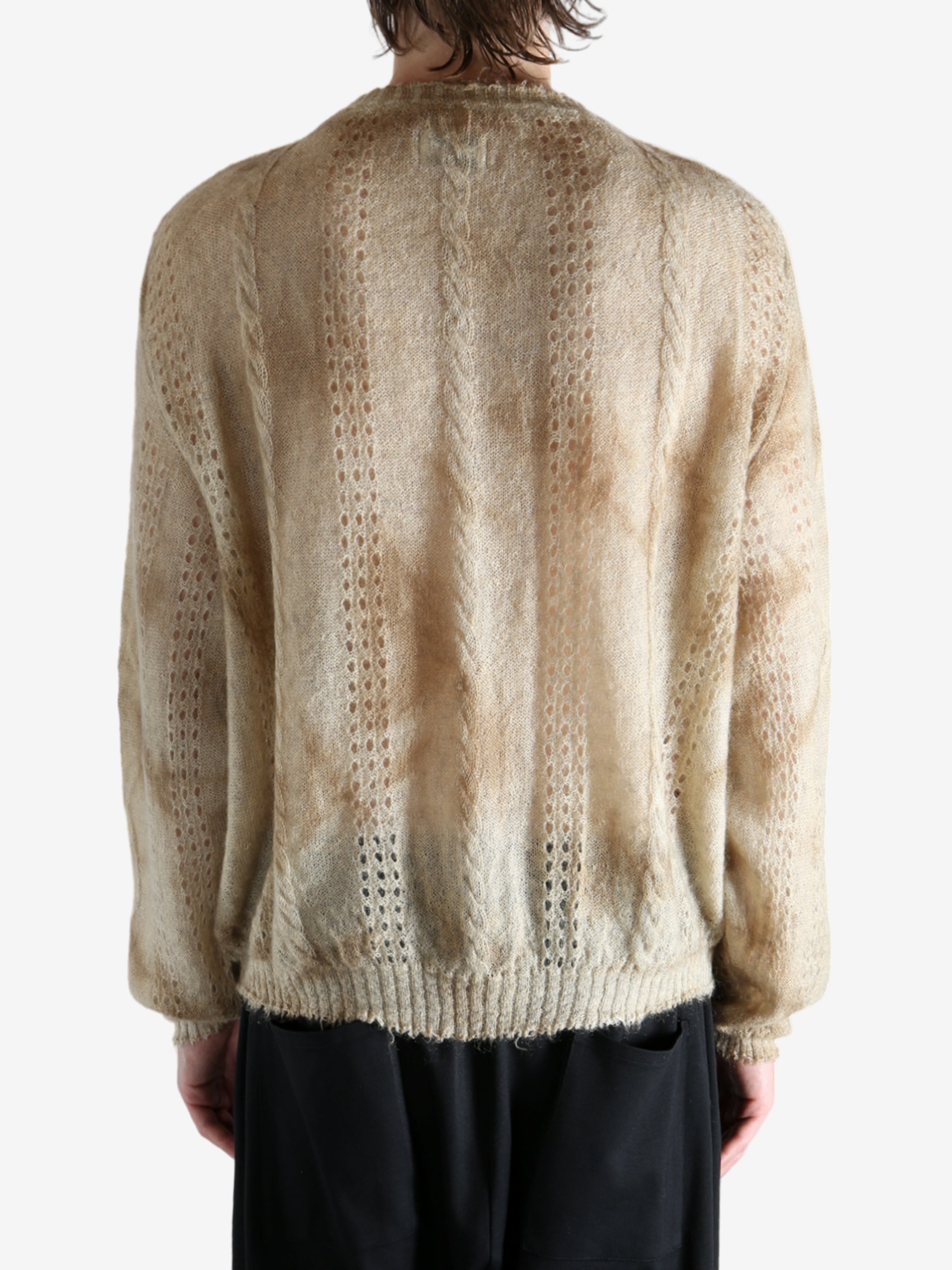 Tan knitwear worn by a person, showing the knitwear's fit