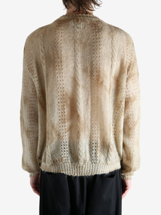 Tan knitwear worn by a person, showing the knitwear's fit