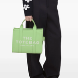 Green bags worn by a person, showing the bags fit