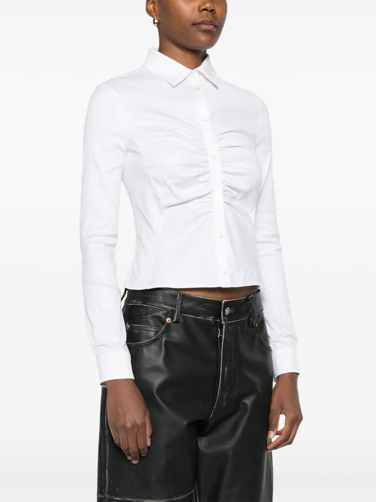 White shirt worn by a person, showing the shirt's fit