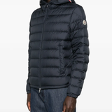 navy jacket worn by a person, showing the jacket fit