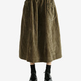 Green skirt worn by a person, showing the skirt's fit