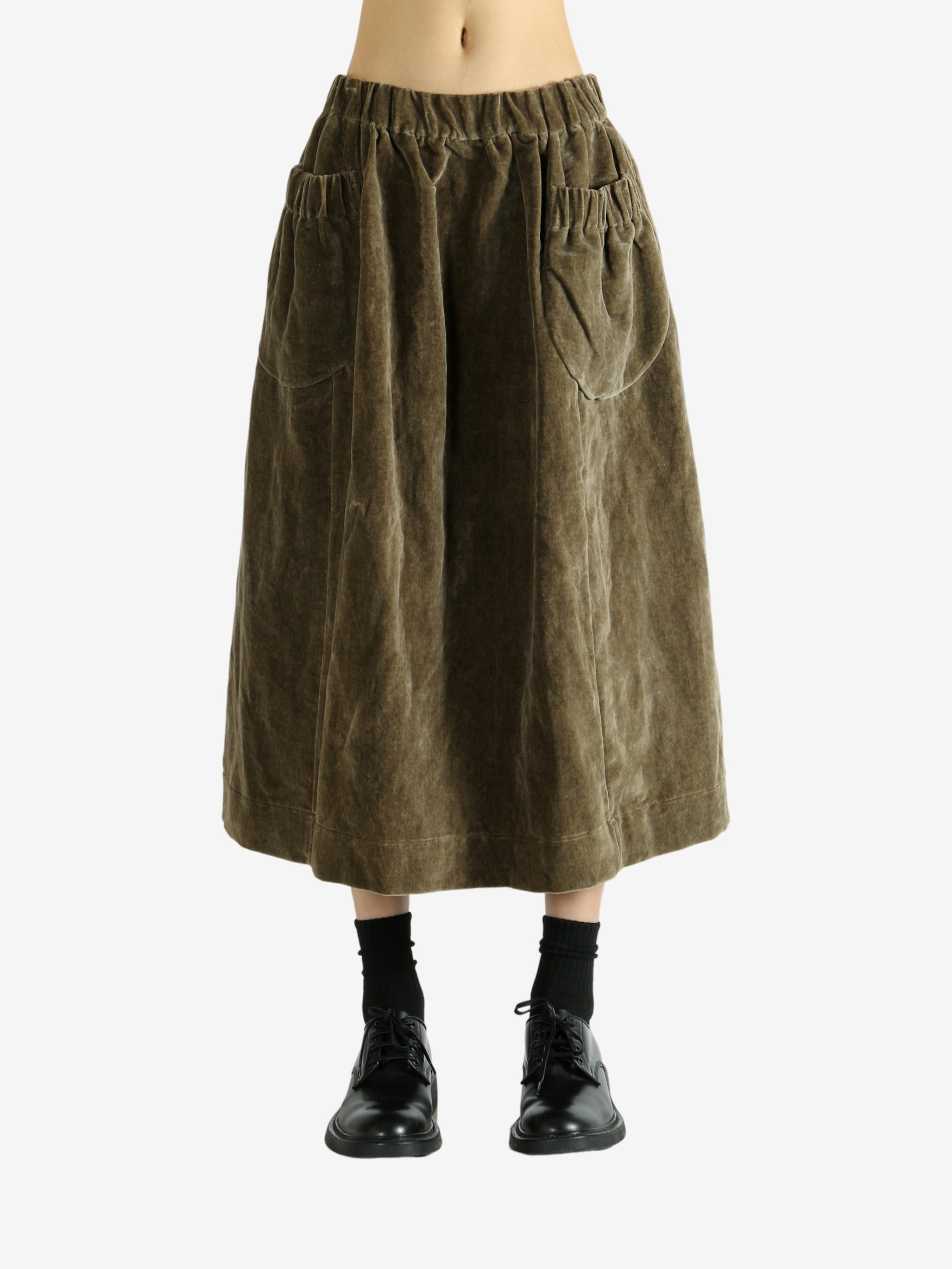 Green skirt worn by a person, showing the skirt's fit