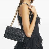 Black bag carried by a person, showing the bag’s fit