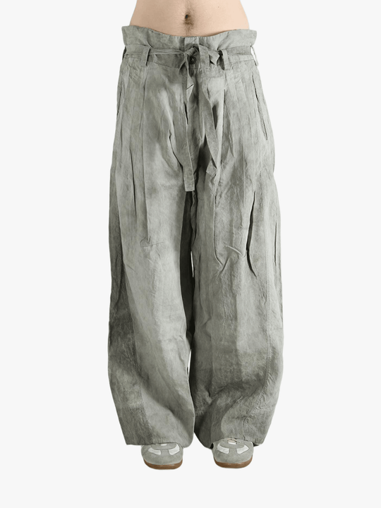 Gray wide-leg pants worn by a person, showing the pants fit